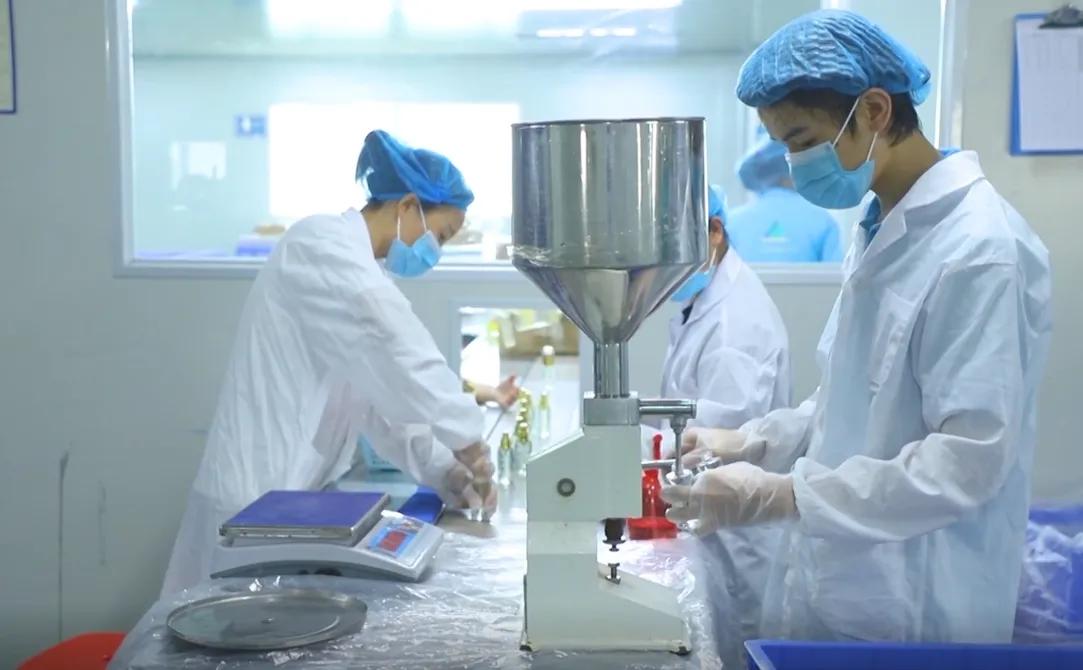 Professional research and development laboratory for hair care and cosmetic products with scientists working on formula development and quality testing